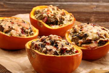 Stuffed autumn pumpkin with rice and mushrooms, seasonal dinner