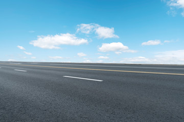 Empty highway asphalt pavement and sky cloud landscape..