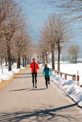 Fototapeta na wymiar Two adults jogging in the winter