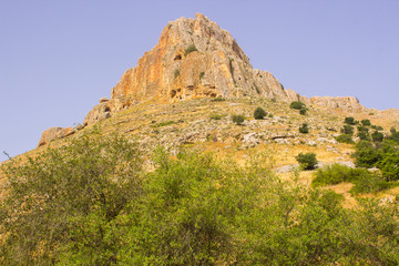 Fototapeta na wymiar The rock face of mount Arbel in the Valley of The Doves in Israel