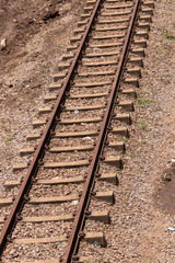 Fototapeta premium A close up view of a straight metal and concrete railway lines