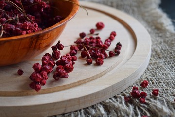 Useful Chinese lemongrass.Dried berry in a plate on a wooden background.