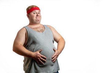 Ironic shot of happy fat man in red hairband exercising with dumbbells and looking at camera...