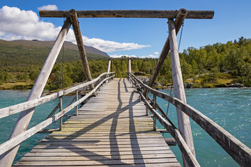 Traditional wooden bridge over the River Sjoa - obrazy, fototapety, plakaty