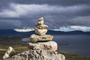 Stone pyramid stands on a hill on a mountain, Norway