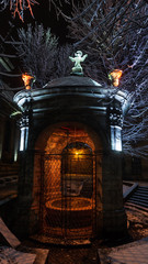 Night winter Lviv city, Ukraine, well in the courtyard of Bernardine Church.