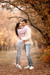 Fototapeta premium Couple in love in the autumn leaves