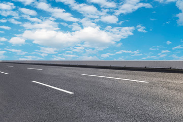 Empty highway asphalt pavement and sky cloud landscape..