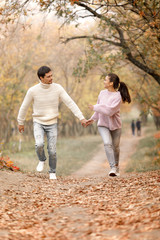 Couple in love in the autumn leaves