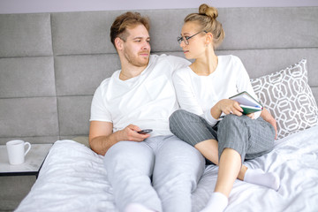 two smiling young man and woman enjoying watching spending weekends together. lifestyle, people,...