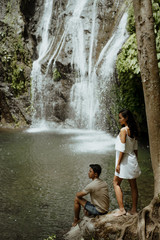 couple looking at banyumala waterfall bali