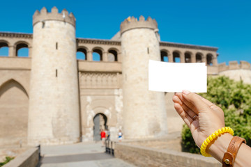 Fototapeta na wymiar Hand holding ticket to historical old site or castle