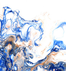 Very beautiful textural background. Blue paint flows in a yellow-gold color on a yellow background. The style includes curls of marble or pulsations of agate with bubbles and cells.