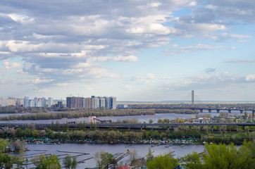 View of the city bridges across the river. Landscape of the summer city of Kiev.