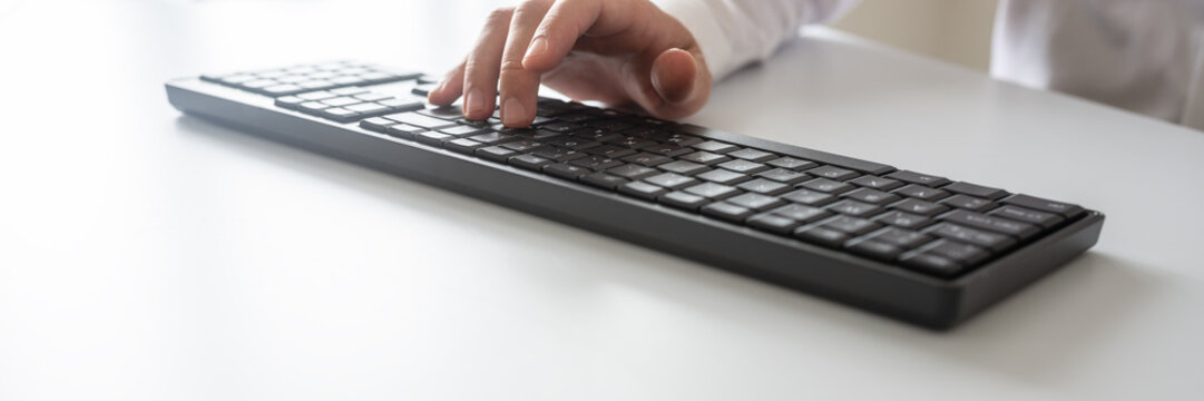 Wide View Image Of Programmer Or Businessman Typing On Black Computer Keyboard