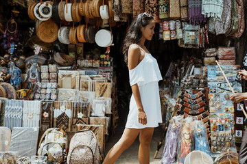 woman walking and looking around at souvenir shop