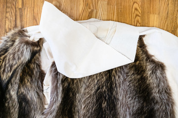 the coat layout with stitched fur pelts on table