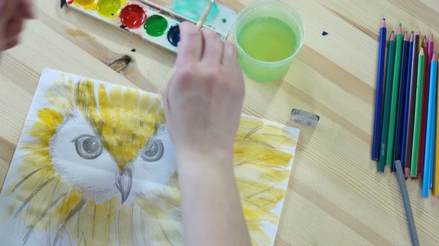 The artist draws a yellow bird