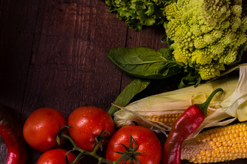 Fresh organic vegetables on wooden background