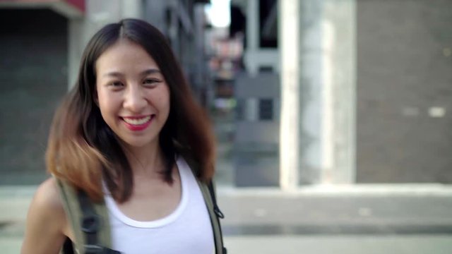 Slow motion - Asian backpacker woman feeling happy traveling in Beijing, China, cheerful beautiful young teenager blogger female walking at Chinatown. Lifestyle backpack tourist travel holiday concept