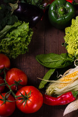 Fresh organic vegetables on wooden background