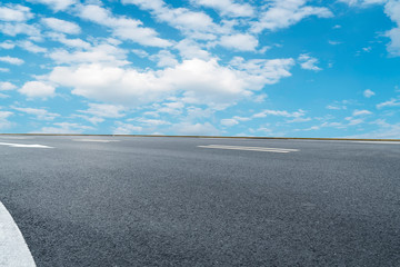 Empty highway asphalt pavement and sky cloud landscape..