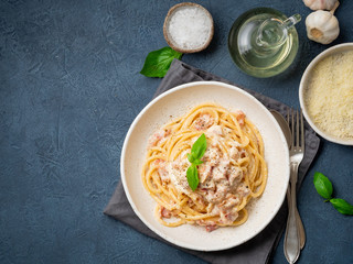 Carbonara pasta. Spaghetti with pancetta, egg, parmesan cheese and cream sauce. Traditional italian cuisine. Top view, copy space