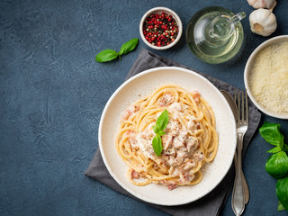 Carbonara pasta. Spaghetti with pancetta, egg, parmesan cheese and cream sauce. Traditional italian cuisine. Top view, copy space