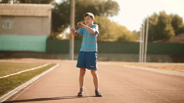 little boy playing sports in a stadium a healthy lifestyle. teen boy doing exercises. gymnastics lifestyle stretch yoga concept