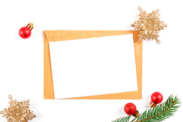 Festive flat lay composition with blank invitation for new year celebration and craft paper envelope. Christmas greeting card template concept. Background, copy space, top view.