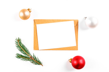 Festive flat lay composition with blank invitation for new year celebration and craft paper envelope. Christmas greeting card template concept. Background, copy space, top view.