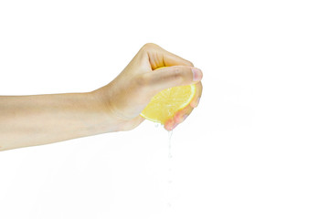woman squeezing half of lemon isolated on white background in the studio