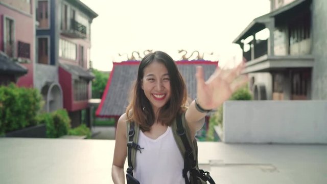 Asian backpacker woman feeling happy traveling in Beijing, China, cheerful beautiful young teenager blogger female walking at Chinatown. Lifestyle backpack tourist travel holiday concept.