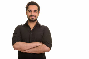 Fototapeta premium Young happy Indian man smiling with arms crossed