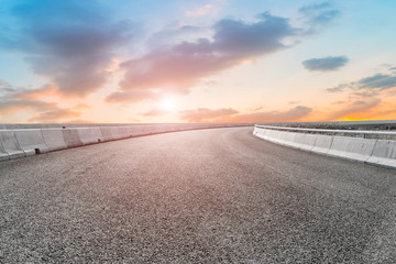Empty highway asphalt pavement and sky cloud landscape..