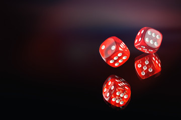 The dice are scattered on a dark red background. Soft tinted image. Gambling poker, roulette.