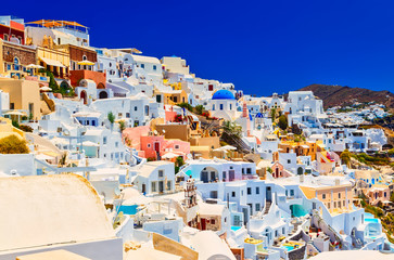 View of Oia the most beautiful village of Santorini island in Greece. slope of the mountain and stretching into the distance on the curve of the tops