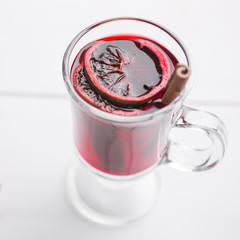 Christmas mulled wine and waffles on white wooden background.