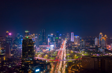 Fototapeta na wymiar Jakarta city with glowing lights in hectic traffic