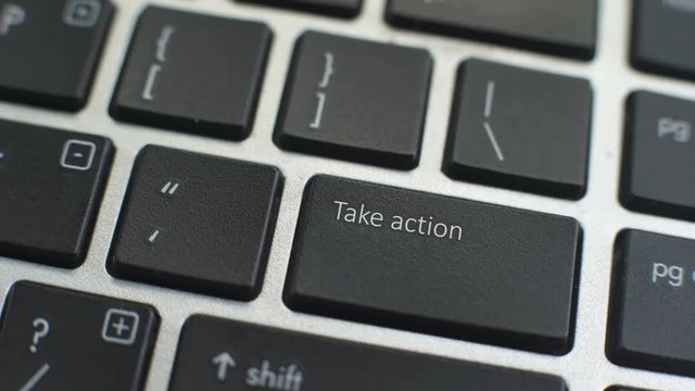 Take action button on computer keyboard, female hand fingers press key