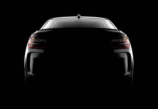 Back view of a generic and brandless modern black car on a dark background