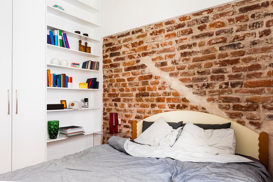 Contemporary bedroom with brickwall