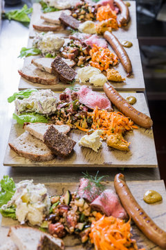 Sausage, charcuterie and these platters in a row