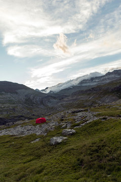 Little red tent on mountains