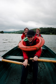 teens and kids on rowboat