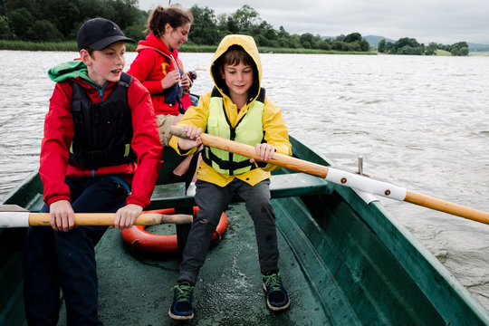 teens and kids on rowboat