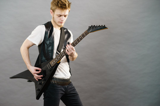 Young man playing electric guitar