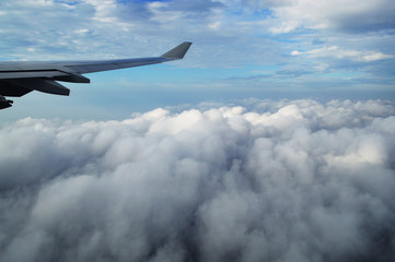 the wing of the plane in the clouds