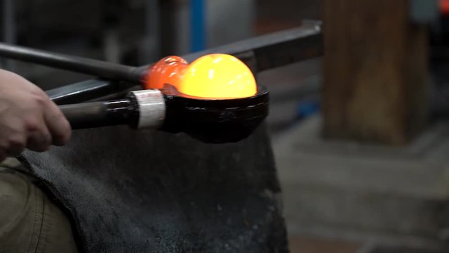 Glassworking Artist Rolls Red-Hot Ball of Glass in Preparation for Blowing 4K