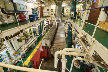 Panoramic view of main engine on a merchant ship in the engine room